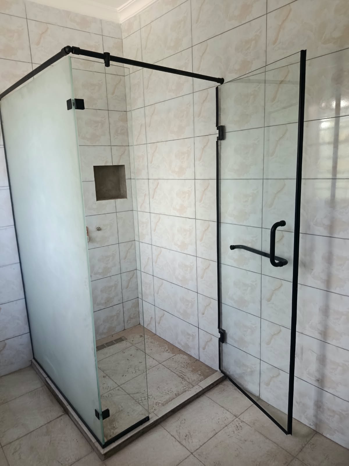 Black-frame frosted shower cubicle